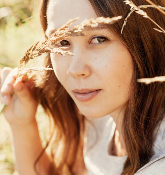 istock Young attractive brunette in the summer rays of the sun 1404176849
