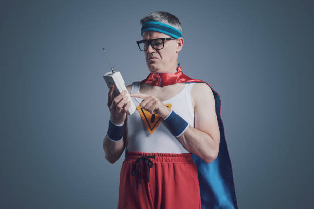 istock Funny superhero having problems with a cordless telephone 1404178110