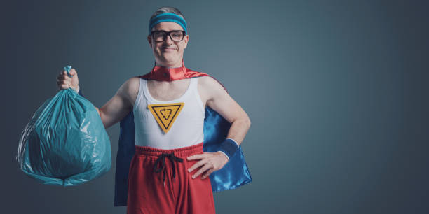 istock Ecology superhero holding a trash bag 1404178132