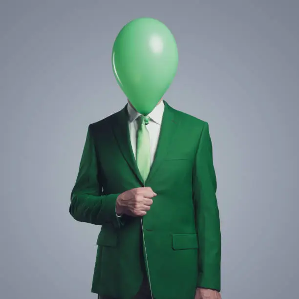 Photo of Anonymous businessman with a balloon in front of his head