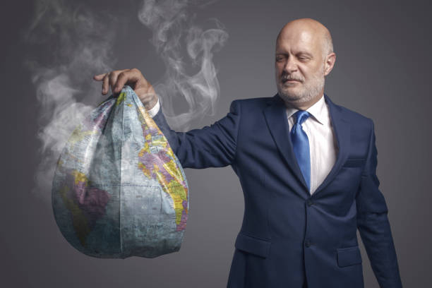 istock Businessman holding a damaged earth 1404178812