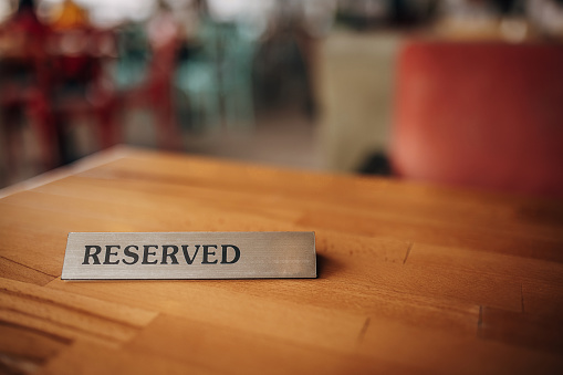 Reserved sign on table in cafe.