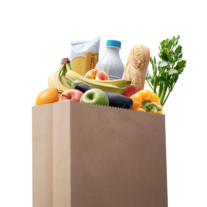 Paper bag full of groceries, grocery shopping concept Isolated on white background