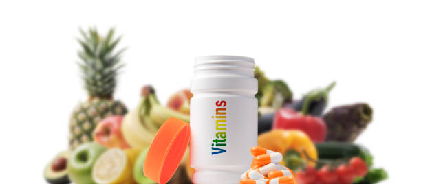 istock Vitamin pills and fresh fruit 1404181011