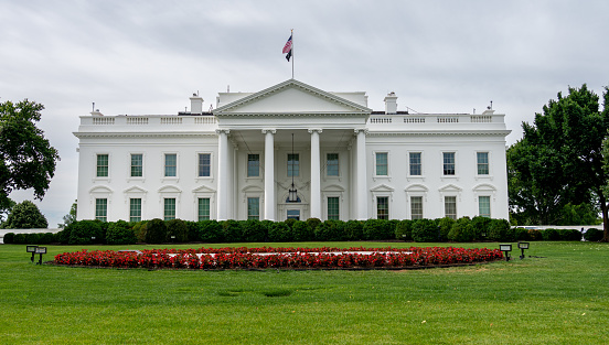 White House in the Spring with Green Grass, Trees, Red Tulips, Fountain and Clear Blue Sky, Washington DC, USA. Canon EF 24-105mm f/4L IS lens.