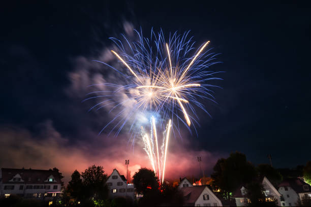 big fireworks over the city of herisau in switzerland on the national holiday august 1. - fireworks imagens e fotografias de stock