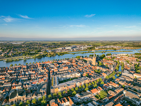 Overhead view on the city of Kampen during a springime evening with sunlight touching the rooftops of the ancient Hanseatic League city on the banks of the river IJssel in Overijssel, Netherlands.