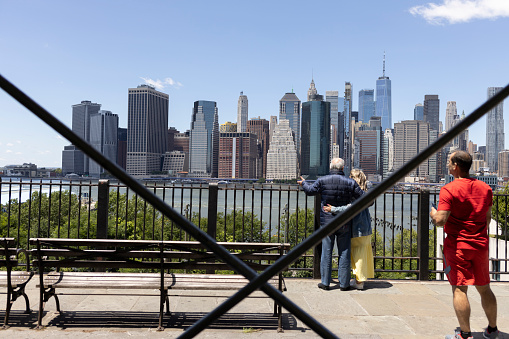 Brooklyn, NY, USA, June 19, 2022: people looking at  Manhattan skyline with scaffolding lines, Brooklyn, NY, USA