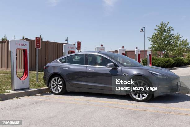 Tesla Ev Electric Vehicle Charging Tesla Products Include Electric Cars Battery Energy Storage And Solar Panels Stock Photo - Download Image Now