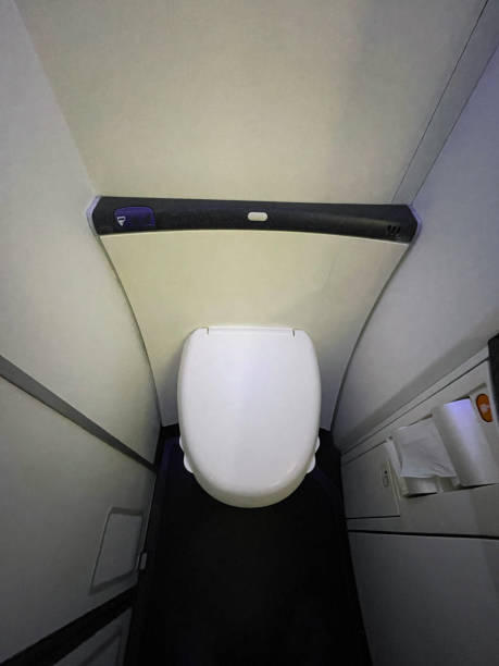 Image of commercial airplane vacuum toilet, aircraft lavatory with plastic lid down on passenger flight, elevated view stock photo