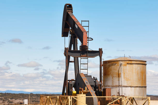 Rusty oil pumping machine. Pump jack. Petroleum extraction. Global warming stock photo