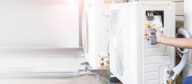 Air conditioner technician checking air conditioner operation. stock photo