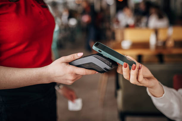 istock Woman paying via smart phone 1404191641