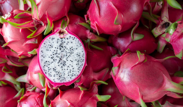 Dragon fruit that has been cut in half for product display. dragon fruit which are beautifully arranged in baskets to prepare for export sale.