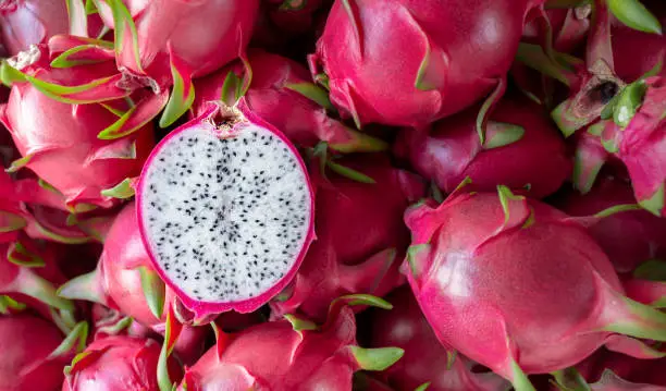 Dragon fruit that has been cut in half for product display. dragon fruit which are beautifully arranged in baskets to prepare for export sale. Dragon fruit of agriculture product on natural background