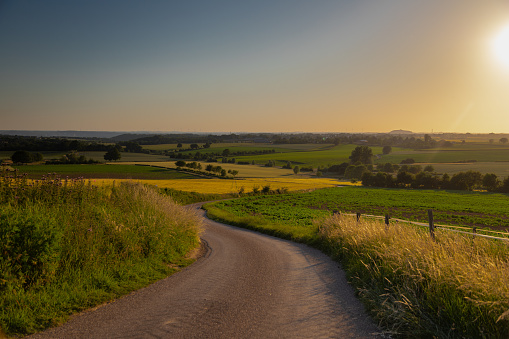 A golden sunset over the rolling hills in Banholt of south Limburg in the Netherlands creating holiday vibes. The views and the warm glow over the landscape create a feeling of being in the Mediterranean.