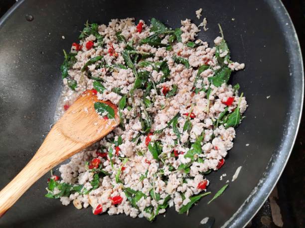 istock Cooking Spicy Chicken Basil - food preparation. 1404193592