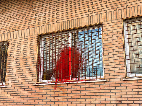 Vandalized window with red paint