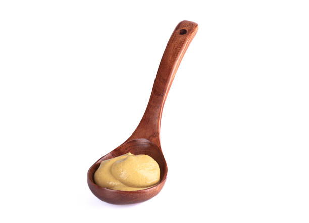 istock Wooden spoon with Dijon mustard on a white background. 1404195734