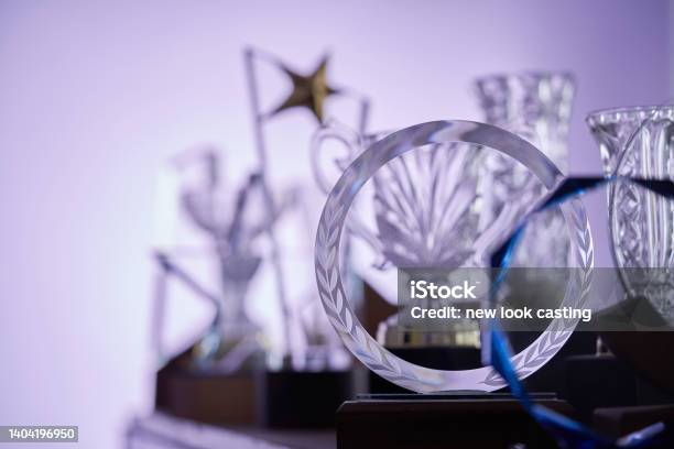 Group Of Crystal Trophies Against Purple Background Stock Photo - Download Image Now