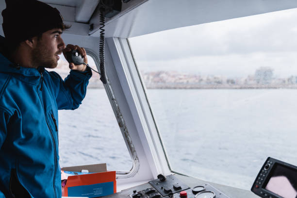 istock Young captain man sailing vintage boat while working during holiday vacation - Focus on face 1404197036