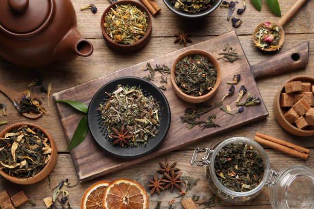 istock Flat lay composition with different dry teas on wooden table 1404197085