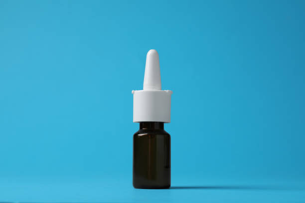 istock Bottle of nasal spray on light blue background 1404198769