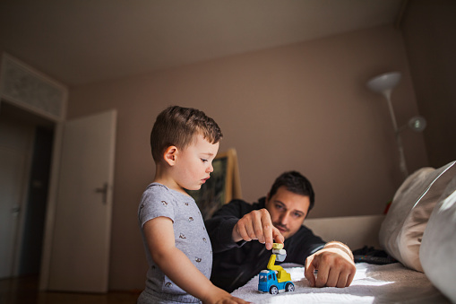 Man playing with son at home