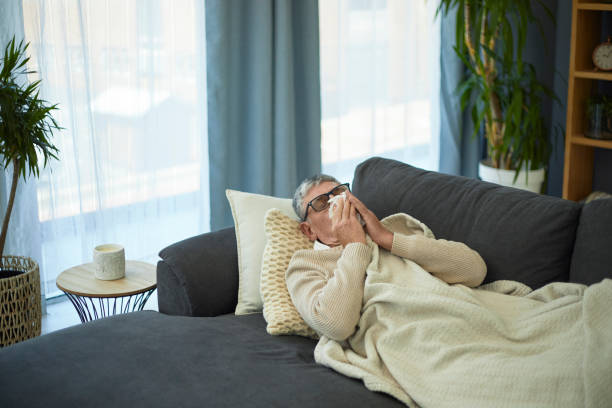 istock Senior man blowing his nose 1404200750