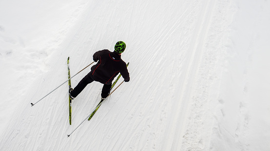 Man Snow Skiing on Steep Slope with Mountain View