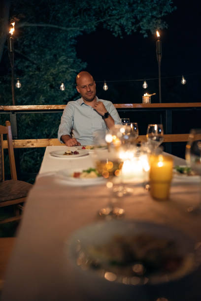istock Caucasian drunk man, sitting for the dinning table alone after the dinner 1404202169