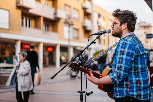 istock Guitar Player On A City Square 1404202196