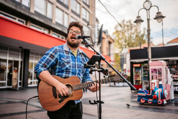 istock Guitar Player On A City Square 1404202294