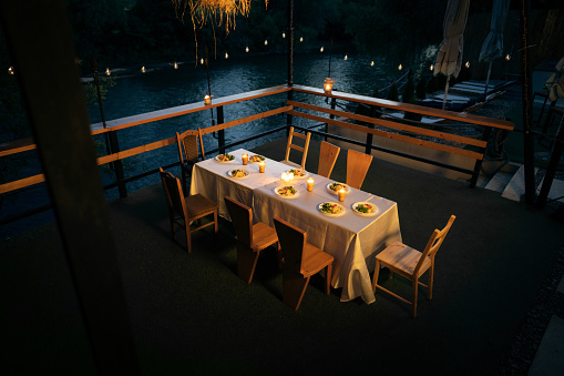 Decorated dinning table, at the romantic restaurant near river, during night