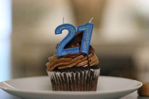 istock 21st Birthday cupcake with 21 candle on top. 1404205537
