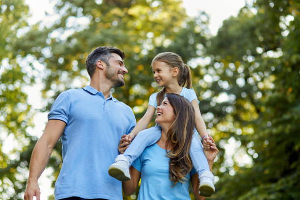 Happy family enjoying spending time together in the park stock photo