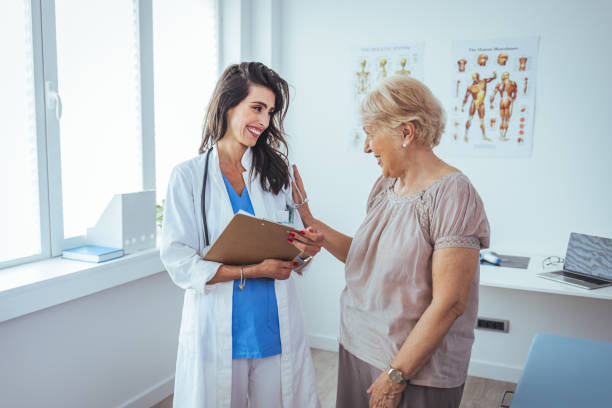 Patient Having Consultation With Doctor In Office Smiling female patient at consultation with woman doctor. Patient Having Consultation With Doctor In Office. Cropped shot of a medical practitioner reassuring a patient outpatient rehab stock pictures, royalty-free photos & images