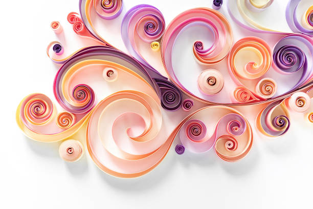 Quilling paper art hobby. Filigree paper abstract floral background in pink-purple tones with copy space. Twisted figures from strips of colored paper 3d image. Quilling paper art hobby. Filigree paper abstract floral background in pink-purple tones with copy space. Twisted figures from strips of colored paper 3d image. paper quilling stock pictures, royalty-free photos & images