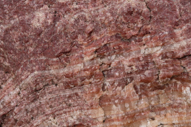 istock The texture of a red mineral. Gneiss rock. Layers. Selective focus. 1404212821