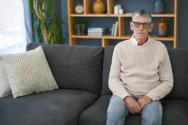 istock Senior man sitting alone at home 1404217520