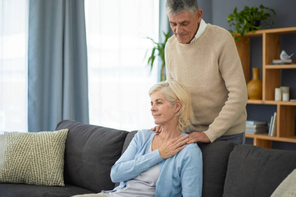 istock Elderly woman getting a massage from her husband 1404218313