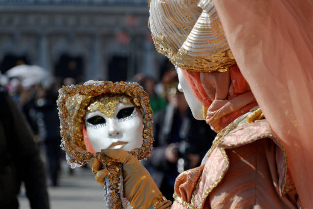 Venice, Italy - February 11, 2024: The Carnival of Venice (Italian: Carnevale di Venezia) is an annual festival held in Venice, Italy, famous throughout the world for its elaborate costumes and masks. \nThe Carnival ends on Shrove Tuesday (Martedì Grasso or Mardi Gras), which is the day before the start of Lent on Ash Wednesday (February-March).\nThe Carnival traces its origins to the Middle Ages, existing for several centuries until it was abolished in 1797. The tradition was revived in 1979, and the modern event now attracts approximately 3 million visitors annually.