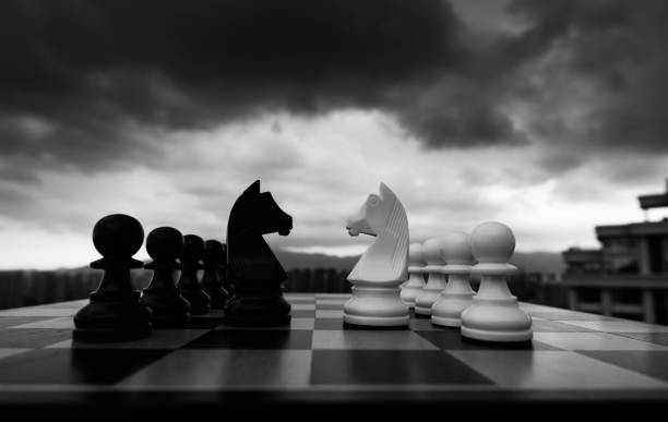 istock Two chess knights battle on city background 1404218552