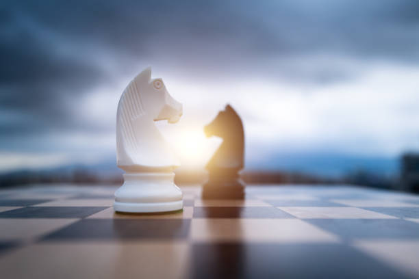 istock Two chess knights on city background 1404218557