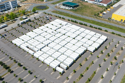 Large parking lot and parked container and truck trailers - aerial view