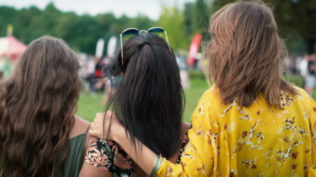 Young friends dancing and walking together at the music festival. Shot with RED helium camera in 8K.