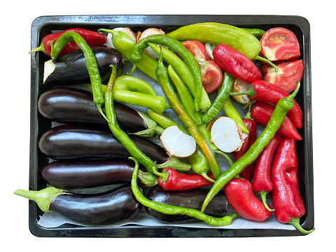 Fresh vegetables in the baking tray isolated on the white background with clipping path