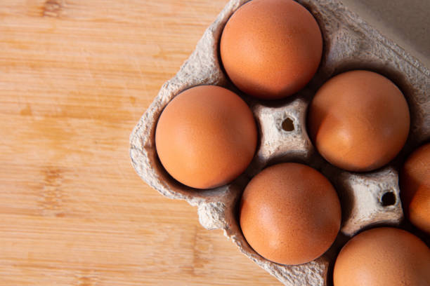 istock Fresh farm eggs in the cardboard boxes for storing eggs. Packaging for chicken made of recycled waste paper 1404224710
