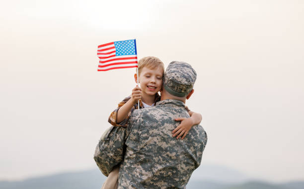 istock Happy boy son with american flag hugging father came back from US army 1404226800