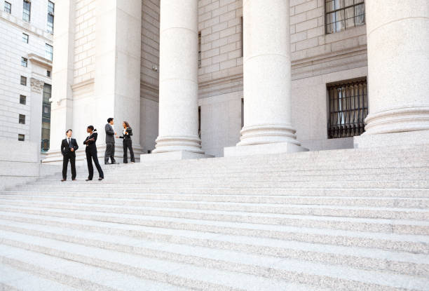 Four Well Dressed People on Courthouse Steps Outside